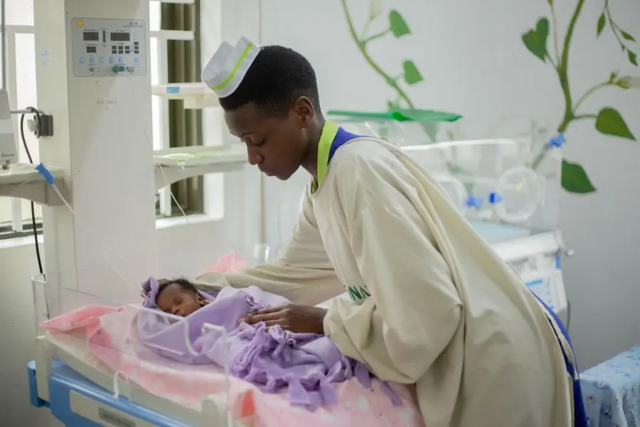 A nurse at the incubator in the newborn unit