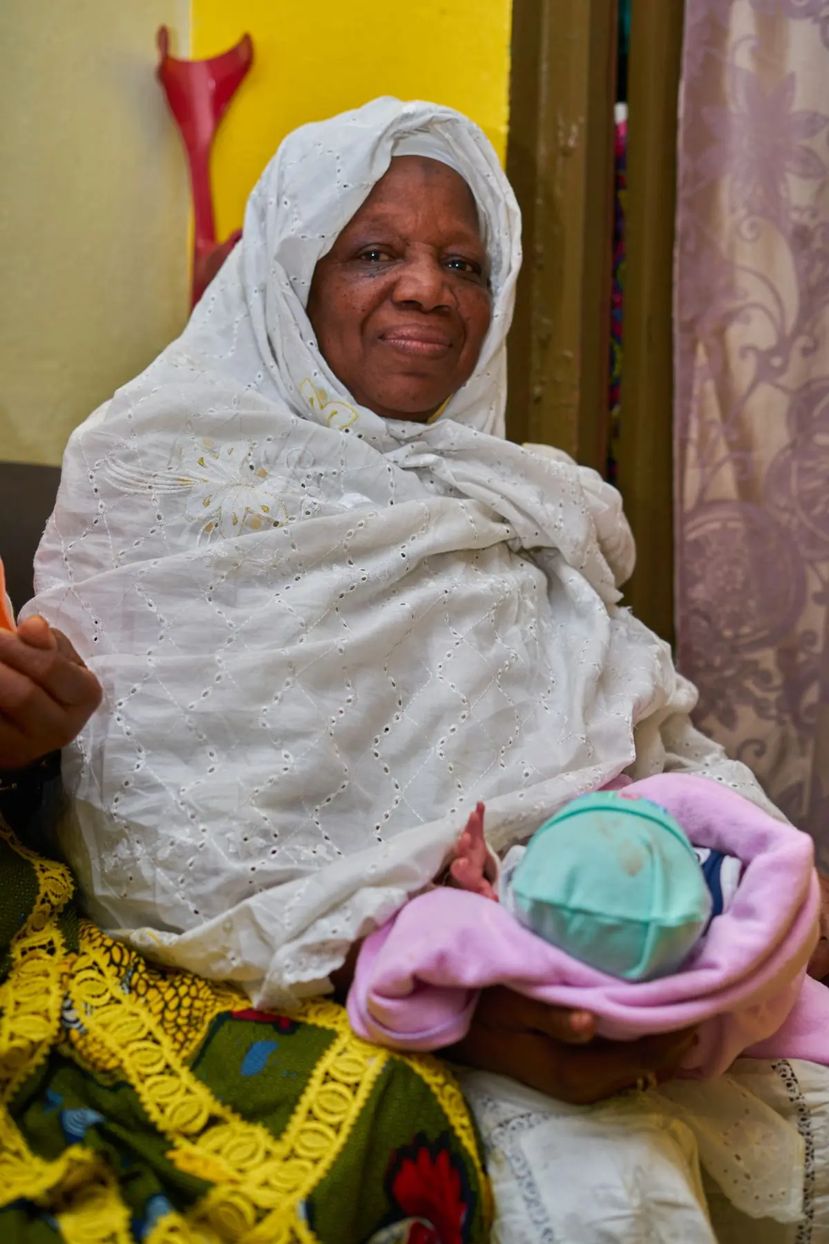 A grandmother holding a newborn in the maternity unit