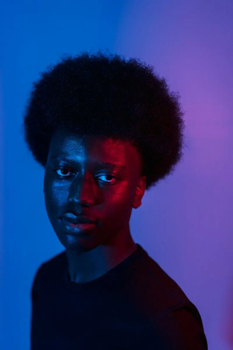 Kojo Mensah-Bonsu, rigging and staging lead, lit in blue and red