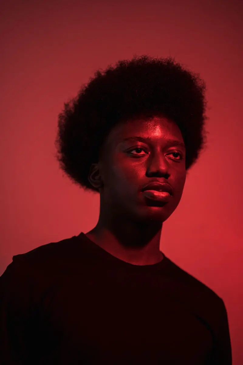 Kwabena Asare, production manager, lit in red