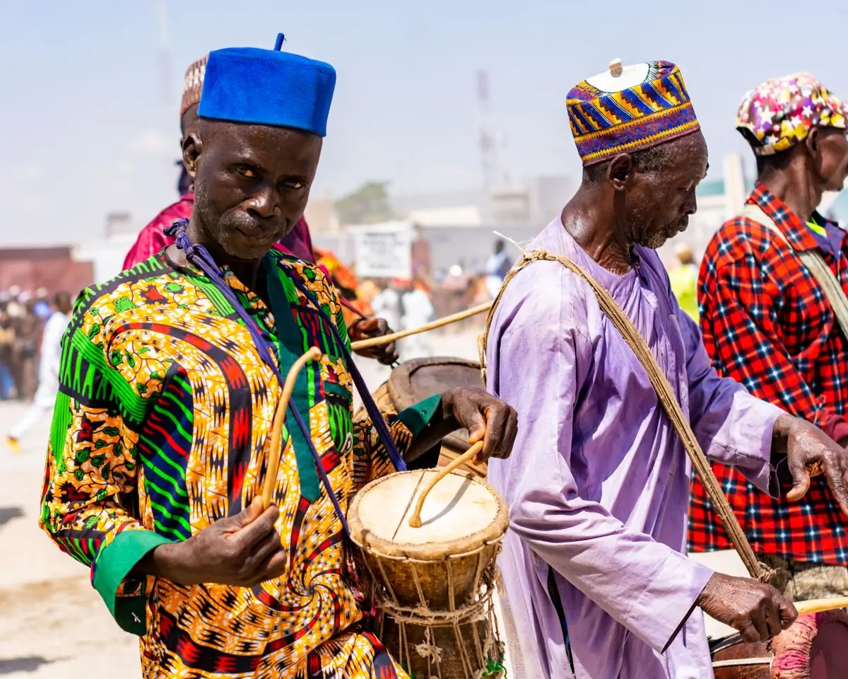 Drummers performing in traditional dress at an outdoor cultural festival