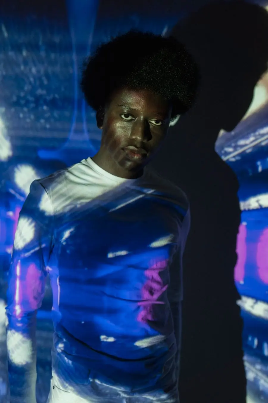 A figure under blue projected light