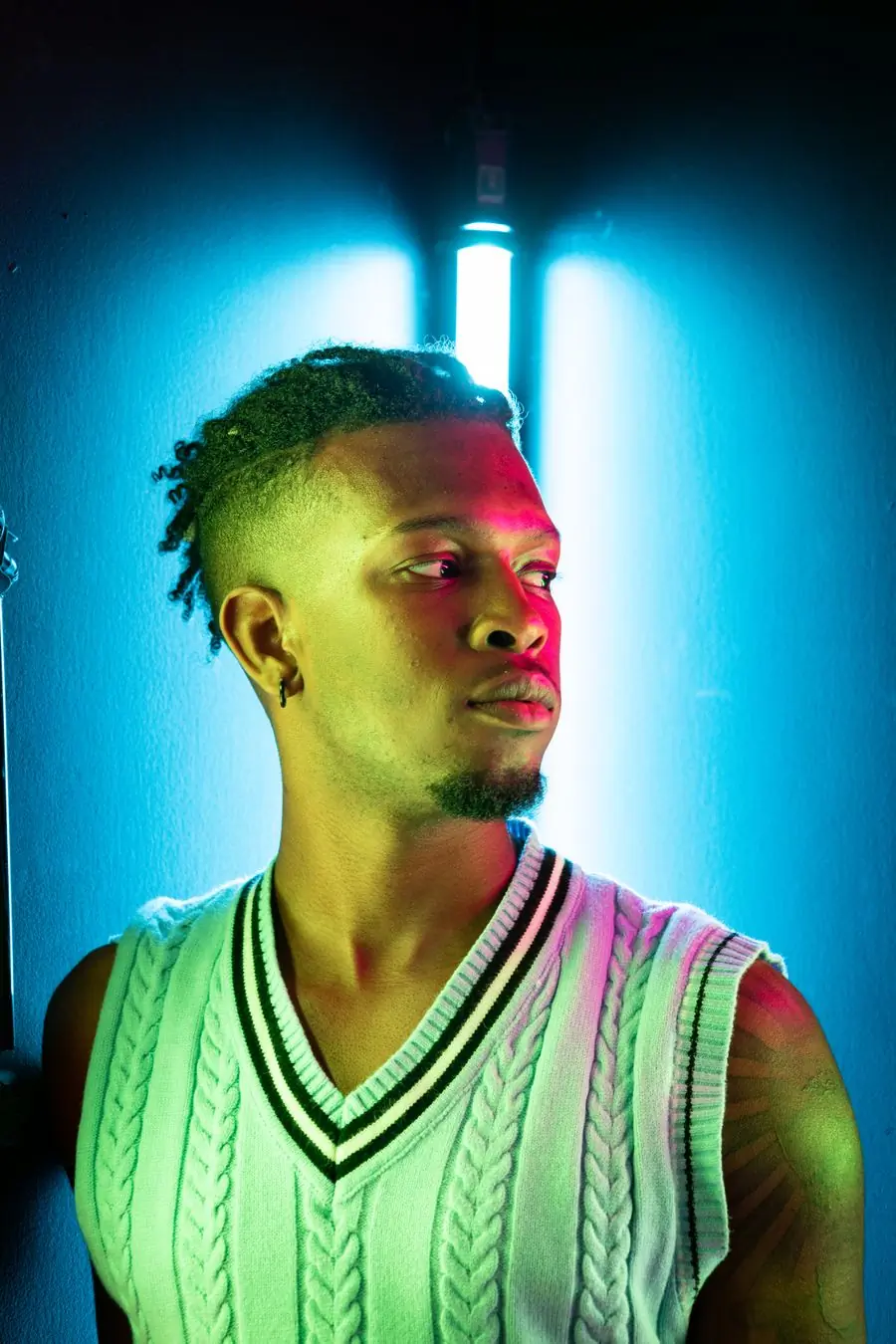 A singer under acid-green stage light