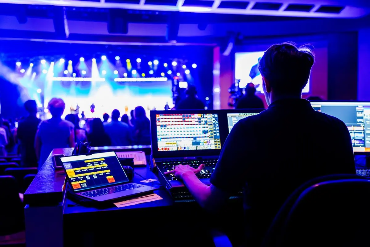 Technicians working lighting and sound control at a live concert