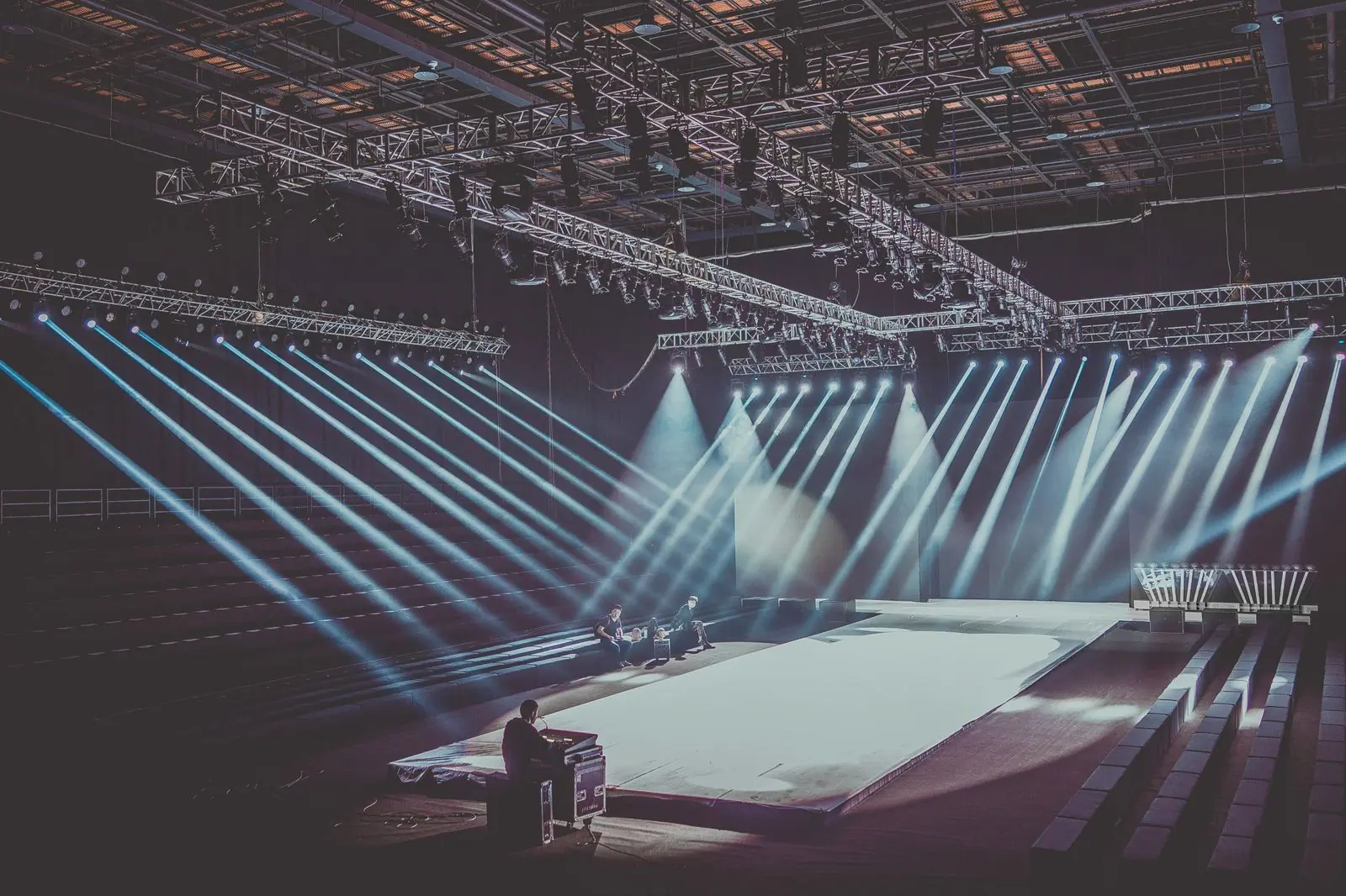 An empty stage under a full lighting rig before an audience arrives