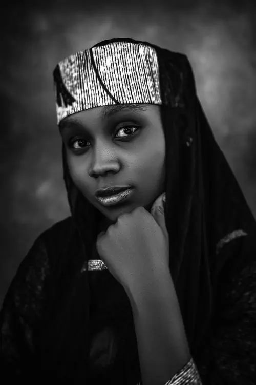 A monochrome portrait of a woman in traditional dress
