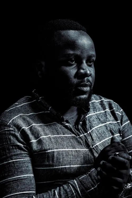 A portrait of a man in a patterned shirt