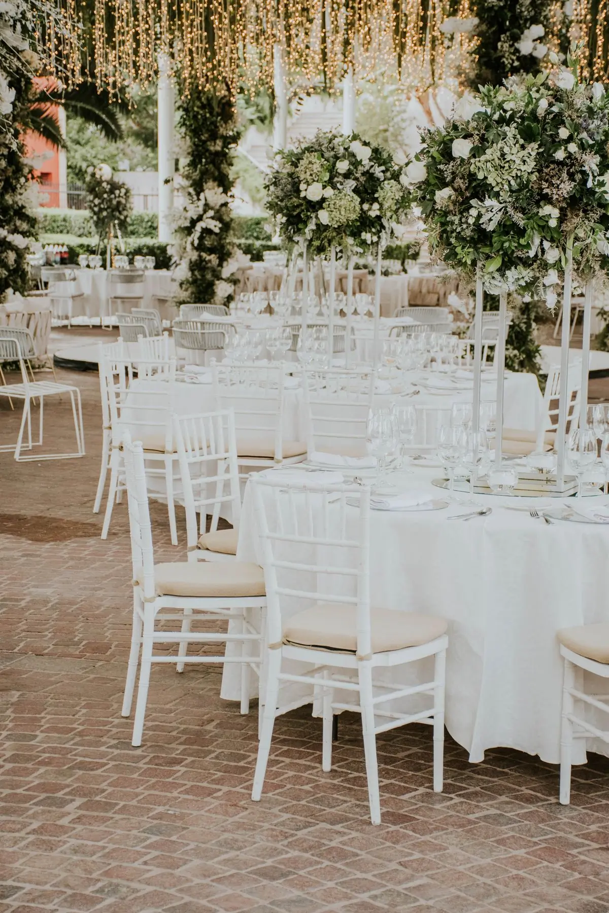 White chairs and dressed tables in a bright reception room