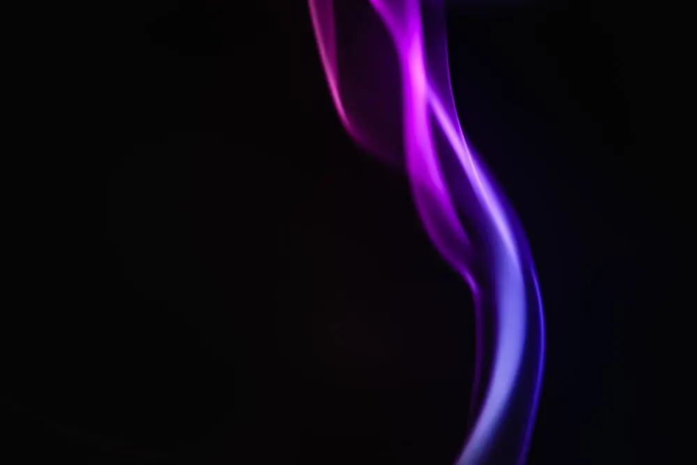 A violet ribbon of smoke on black, the sleeve of the album Harmattan Skin