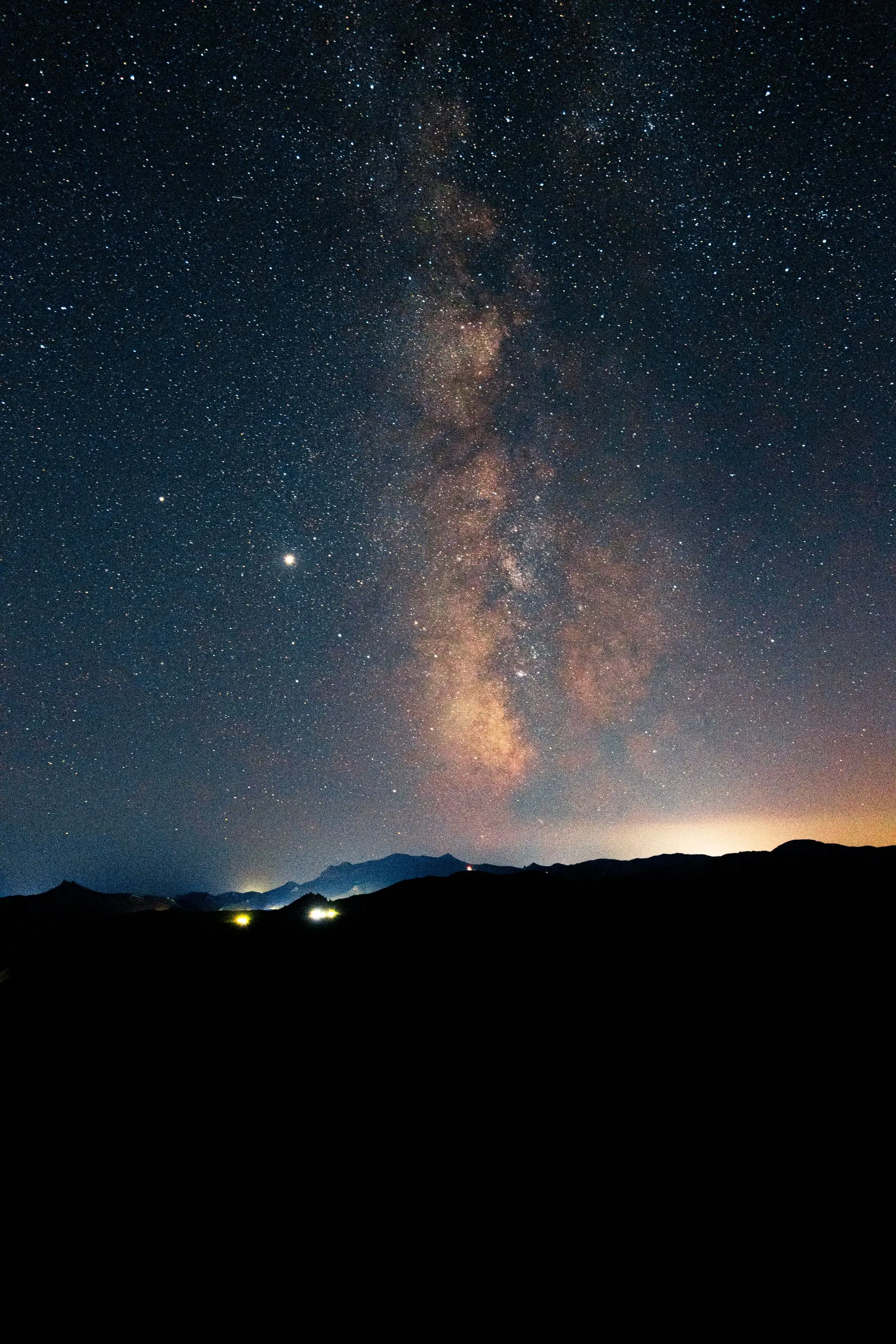 The Milky Way over a silhouetted mountain range at night