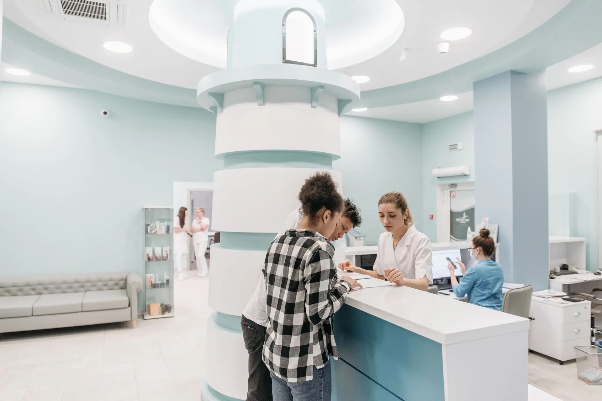 A patient being booked in at the front desk