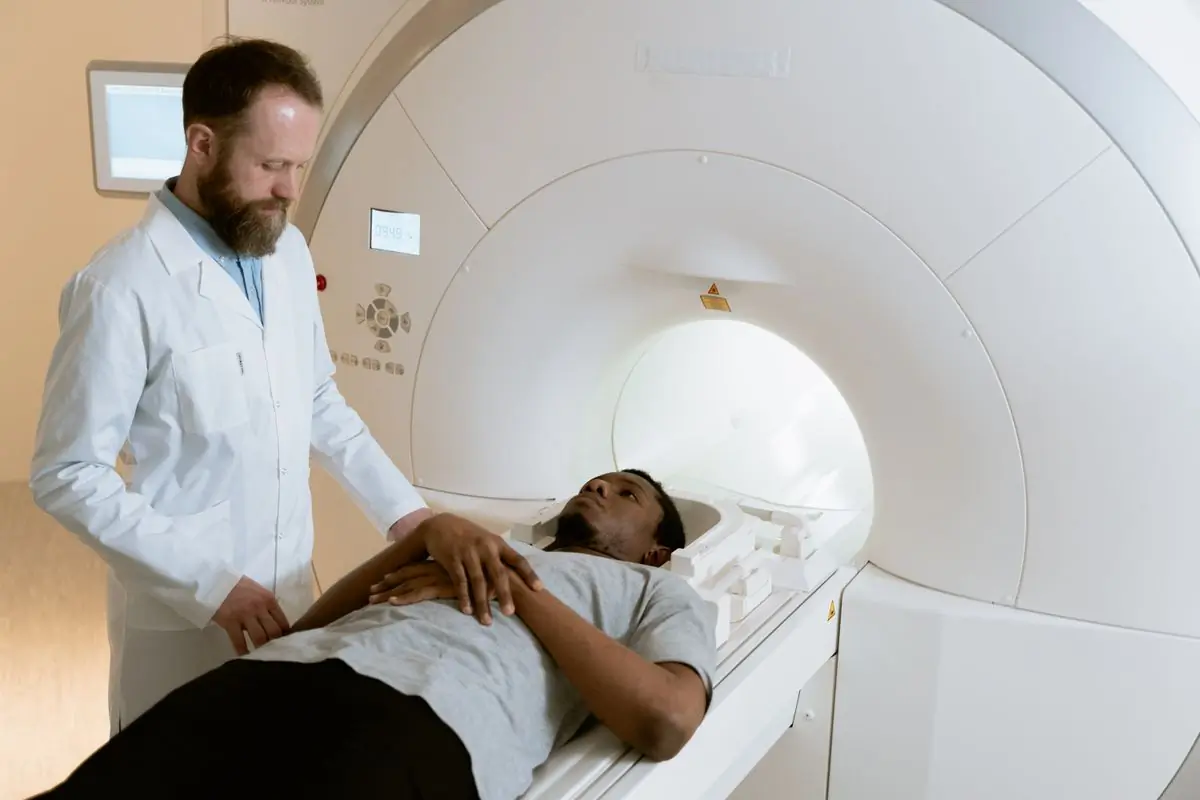A radiographer positioning a patient for an MRI scan