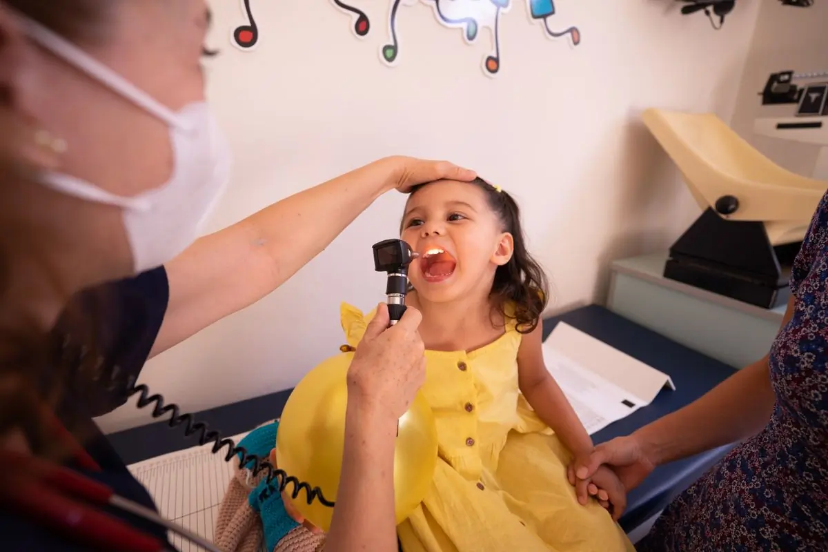 A paediatrician examining a young patient in the clinic